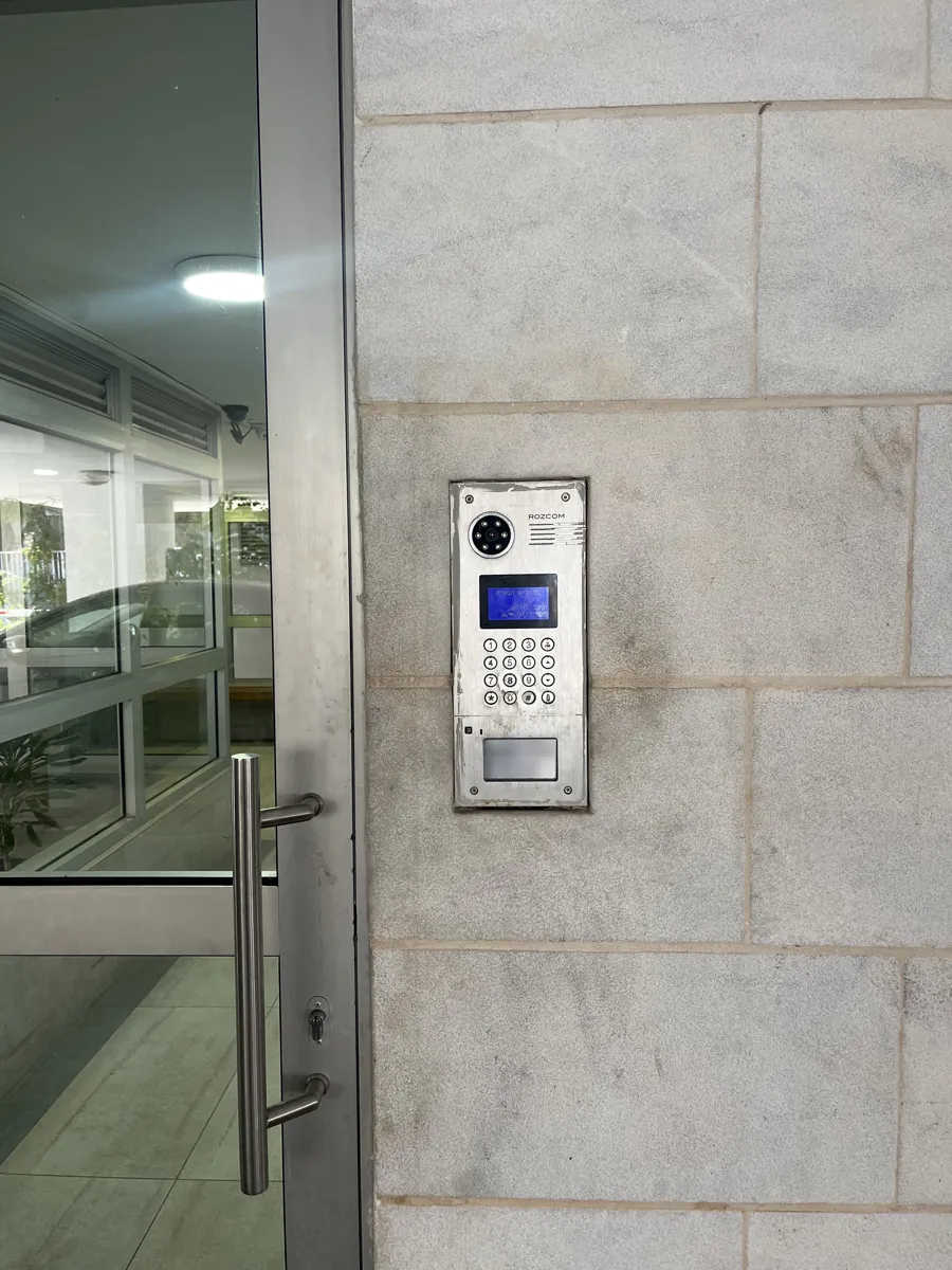A building entrance with its existing intercom panel
