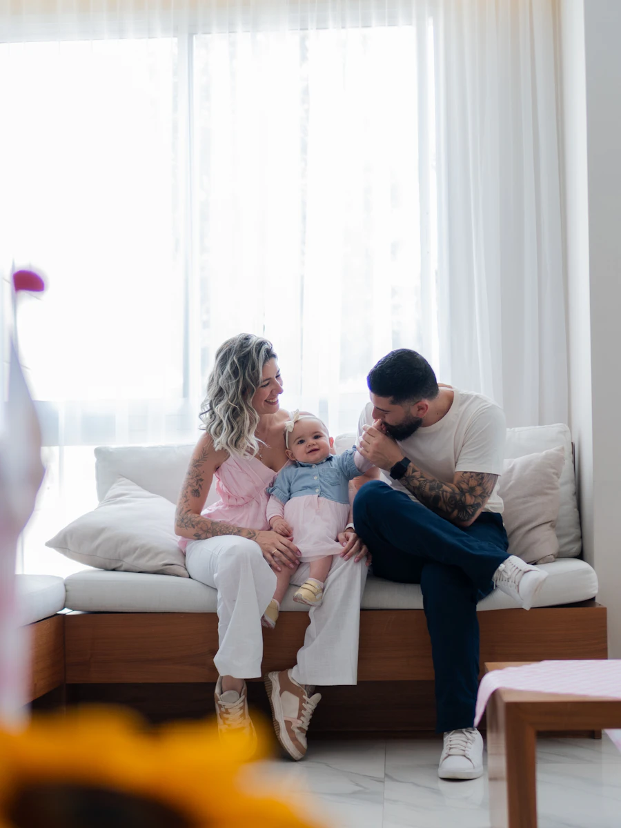 A family with their baby in the living room of their apartment